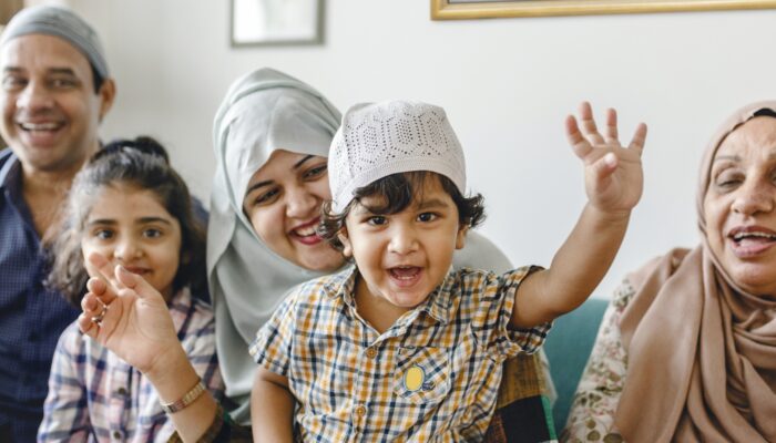 Muslim family relaxing and playing at home