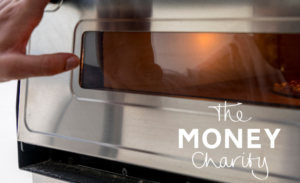 The Money Statistics September 2024 - Heat Or Eat Challenges Loom For Many Over Coming Months - Image shows an oven, with a hand gently resting on the outside handle, giving the impression of a decision being made whether to use it or not.