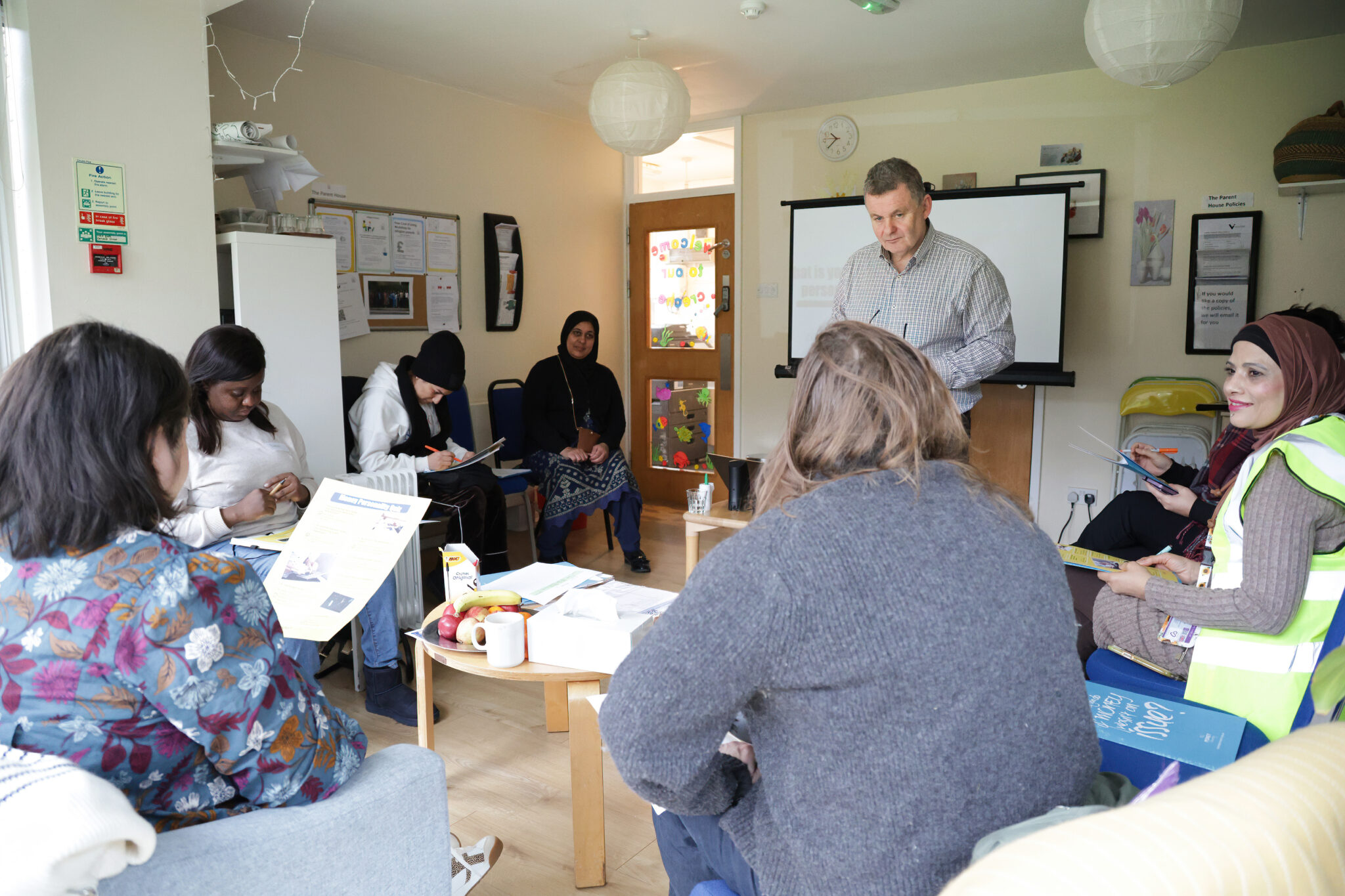 A group of people having a discussion with a male facilitator